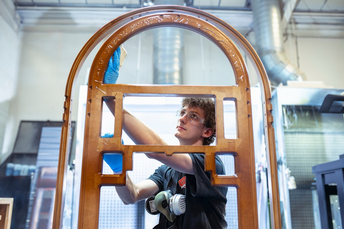 Craftsman finishing a jukebox arch in the Yorkshire workshop