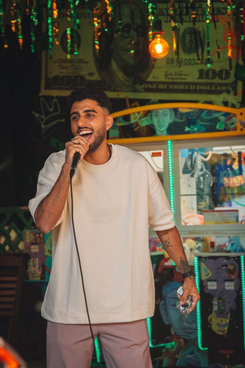 Guest singing into the microphone with a big smile